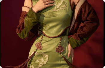 Green embroidered qipao with red tassels